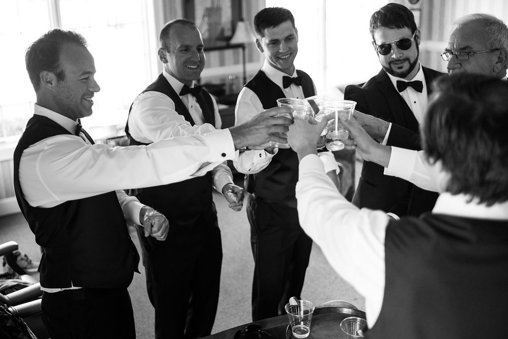 Groom giving toast with tequila shots in Pilot Knob Country Club. Wedding Photography by Party of Two Photography.