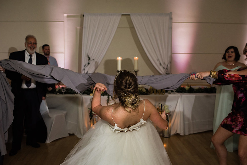 Bride Dancing Limbo at Levine Museum of the New South Reception from Charlotte Wedding Photographer