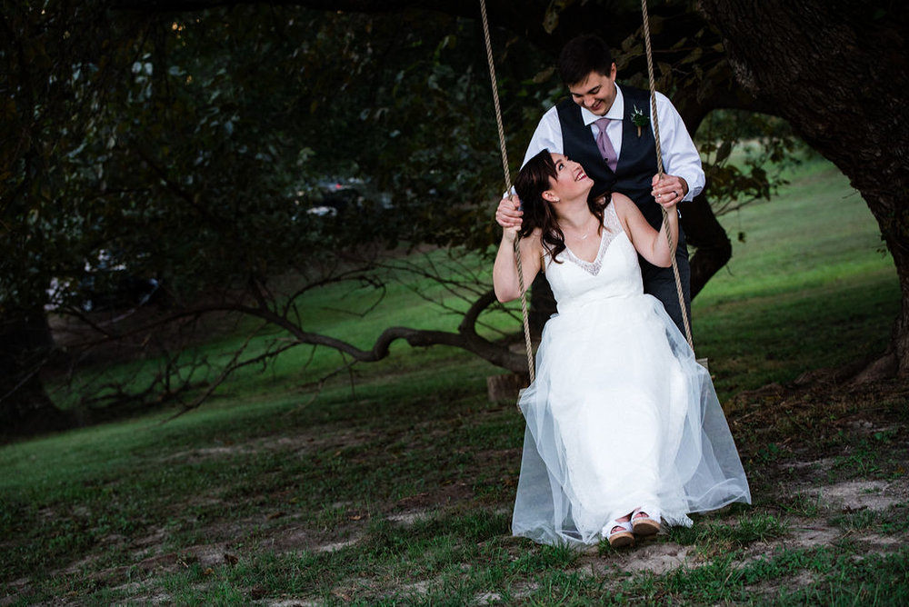 Bride and Groom Sunset Portraits on Swing at The Oaks at Salem Wedding in Apex, NC by Charlotte Wedding Photographers