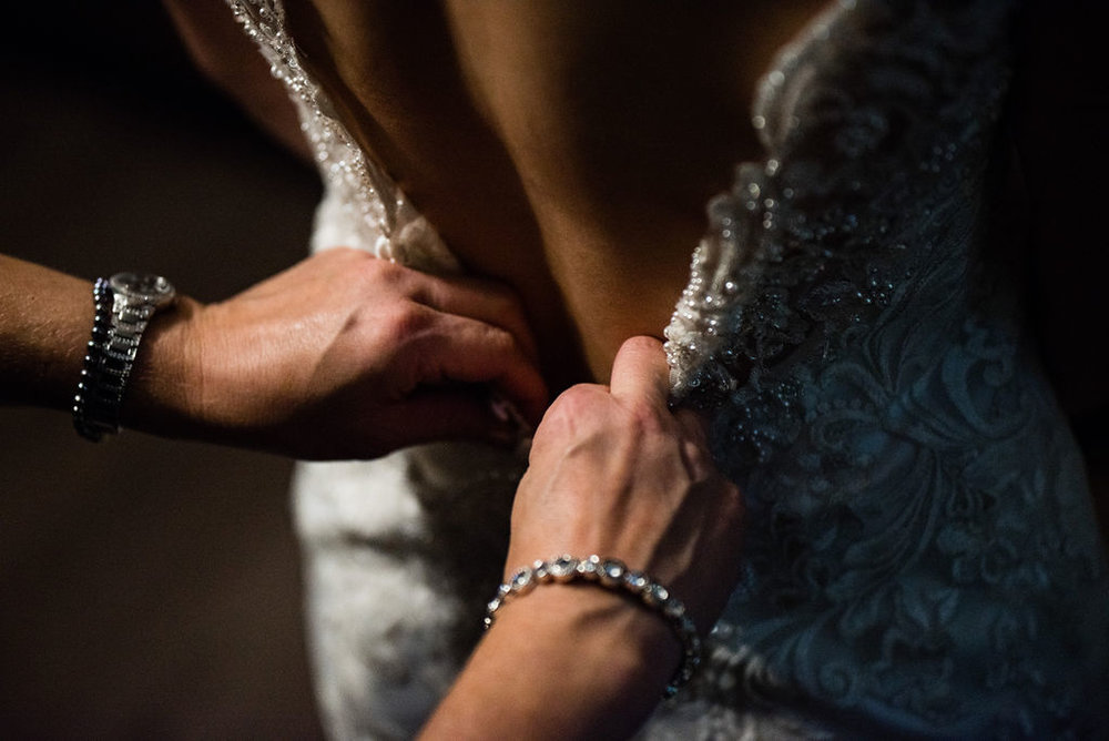 Bride Getting in Dress Details by Charlotte Wedding Photographers