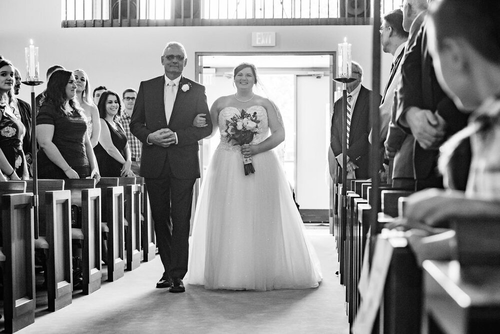Bride walking down the aisle at ceremony at Pleasant Grove United Methodist Church Raleigh wedding by Charlotte Wedding Photographers