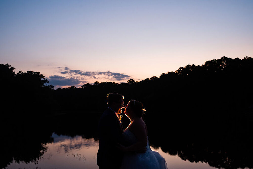 Bride and groom sunset portraits at Campbell Lodge Reception, Durant Nature Preserve, Raleigh wedding by Charlotte Wedding Photographers
