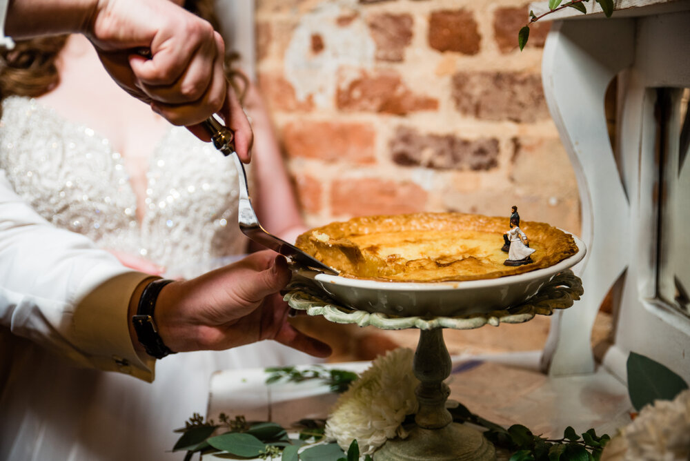 Fall Laboratory Mill Wedding reception pie cutting by Charlotte Wedding Photographers