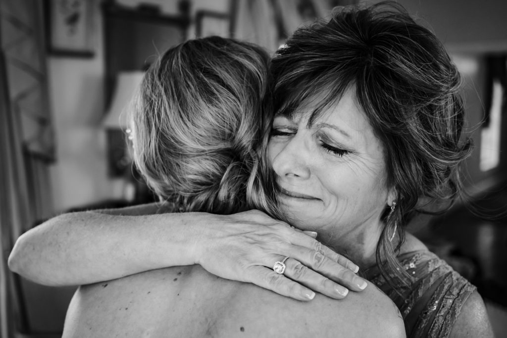 Sweet moment of bride and mom hugging