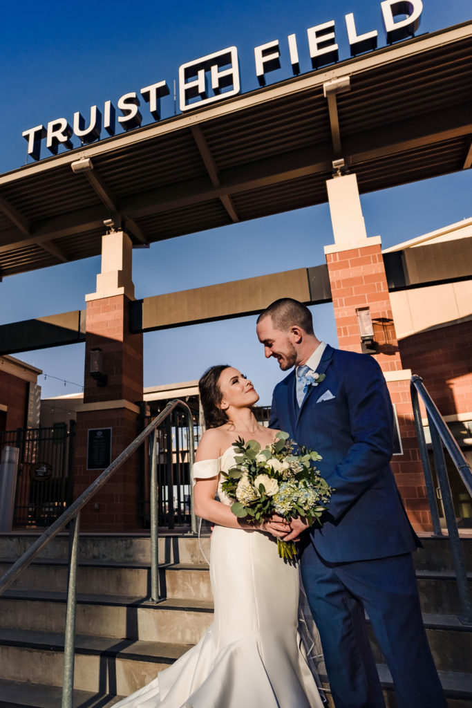 Uptown Charlotte Wedding Portrait in front of baseball field