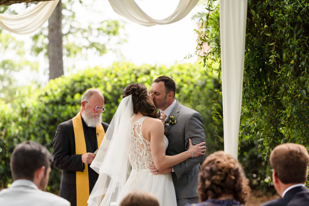 First Kiss in outdoor ceremony during Whitehead Manor Wedding in Charlotte NC