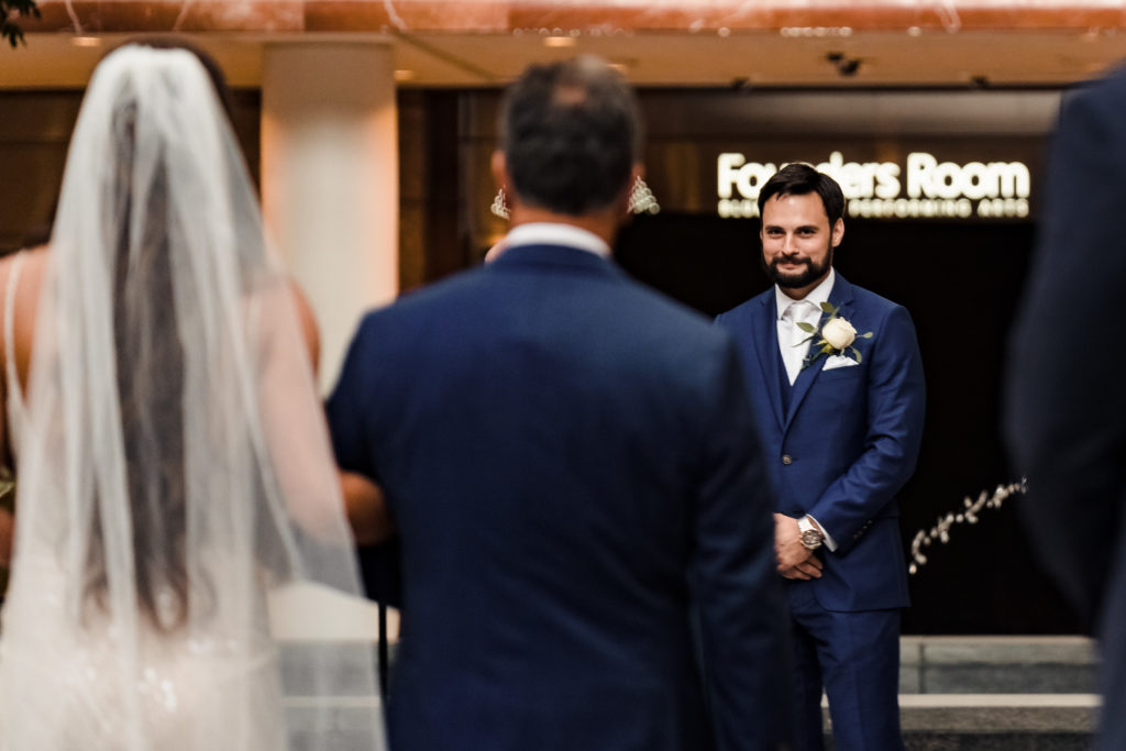 Groom seeing bride for first time during wedding at Founders Hall in Charlotte NC