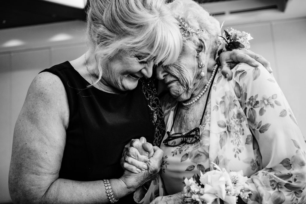 Emotional picture of bride's mom and grandmother during her wedding at Springhill Suites in Uptown Charlotte