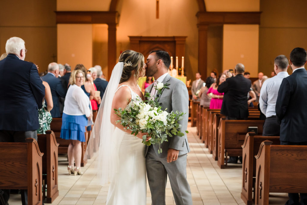 Kiss during exit at St. Mark Catholic Church Ceremony