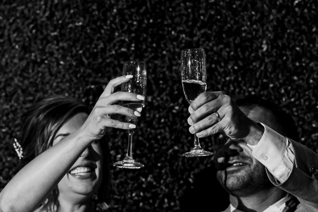 Black and white bride and groom champagne toast at Riverwood Manor Wedding Reception