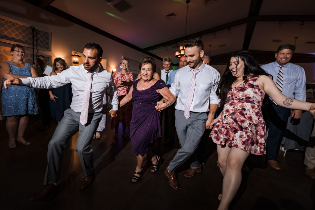 Groom and guests dancing during Riverwood Manor Wedding Reception