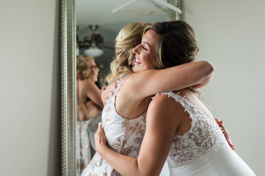 Sweet hug between bride and mother at home