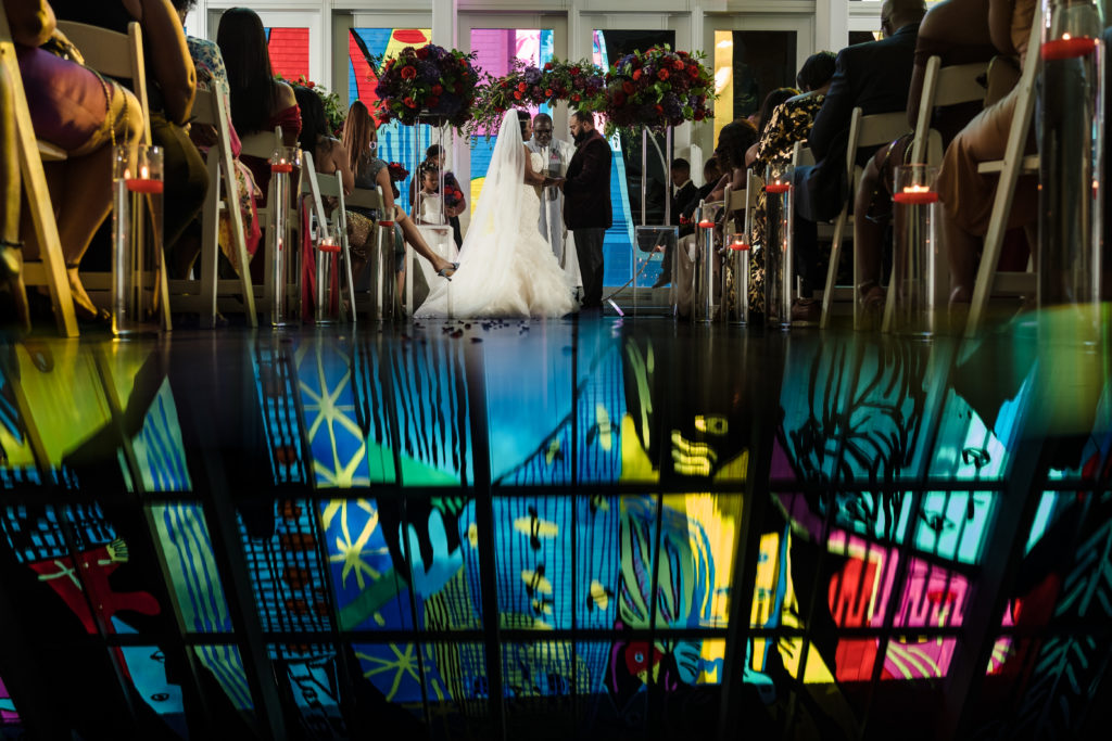 Creative reflection of Mint Museum artwork during wedding ceremony in Uptown Charlotte.