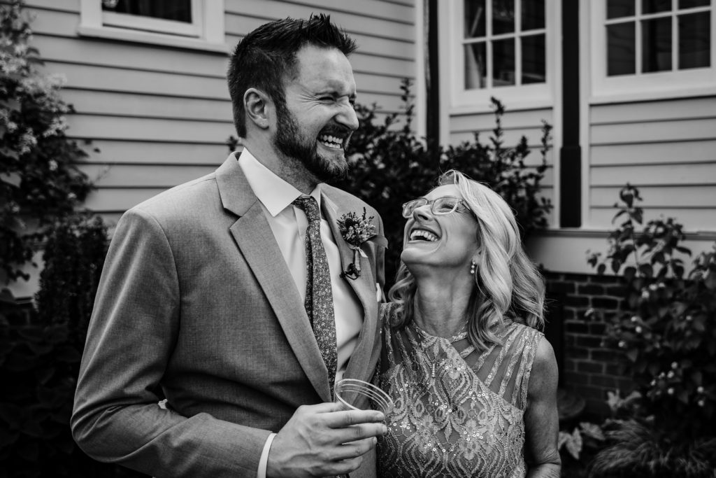 Groom and his mother laughing before the wedding ceremony at Alexander Homestead, located in Charlotte NC.