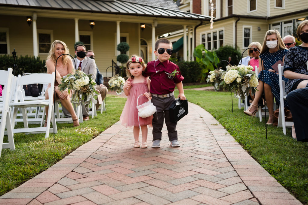 Cute kids walking down paved aisle as ring bearer and flower girl. This is a great way to have kids at a wedding.