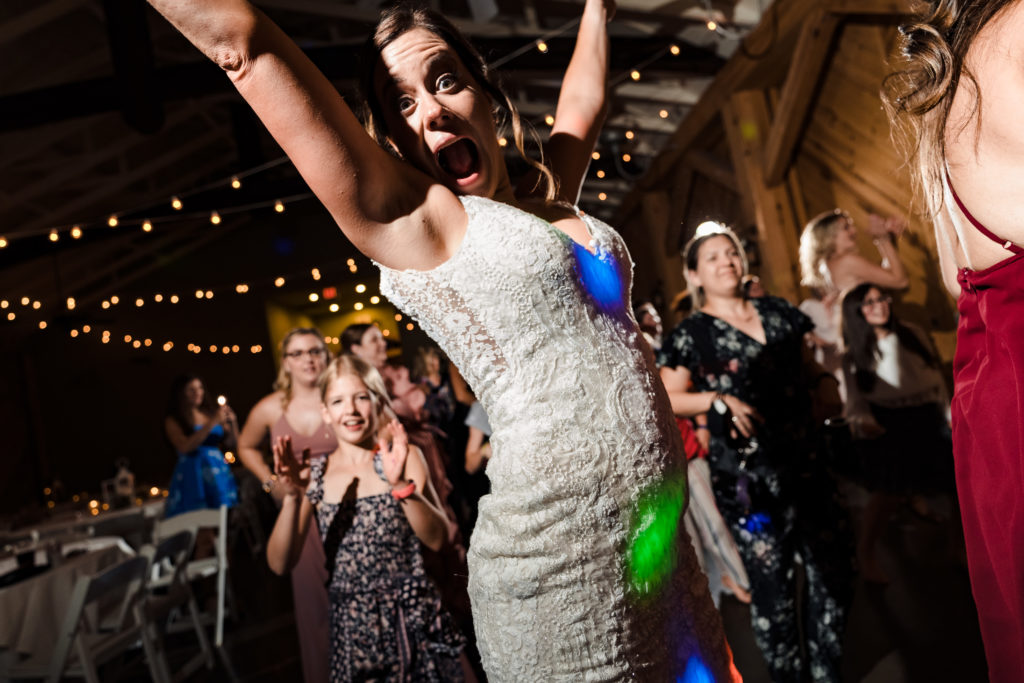 Megan jumps up in the air and makes a hilarious face during her wedding reception at Alexander Homestead.