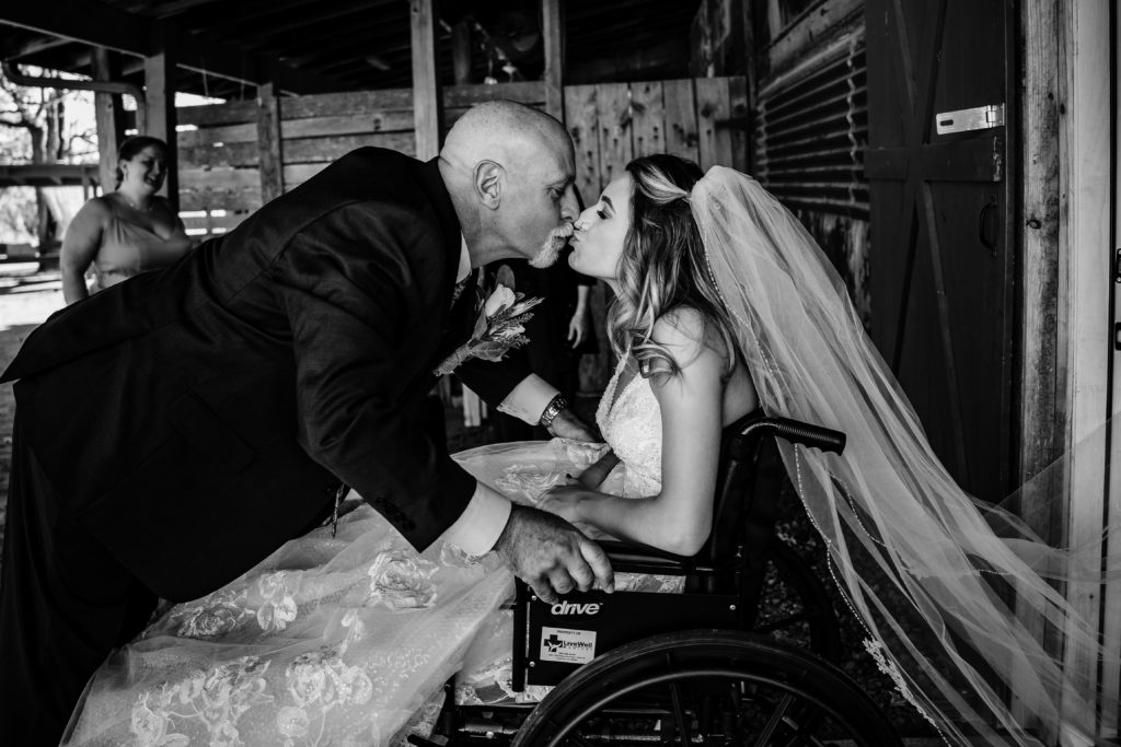 Bride in wheelchair has wedding first look with her father