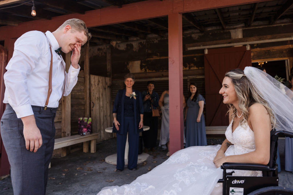Bride in wheelchair has wedding first look with groom