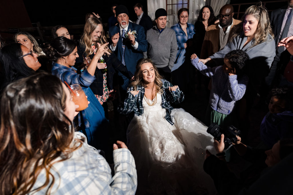 Bride dances while in a wheelchair at the wedding reception