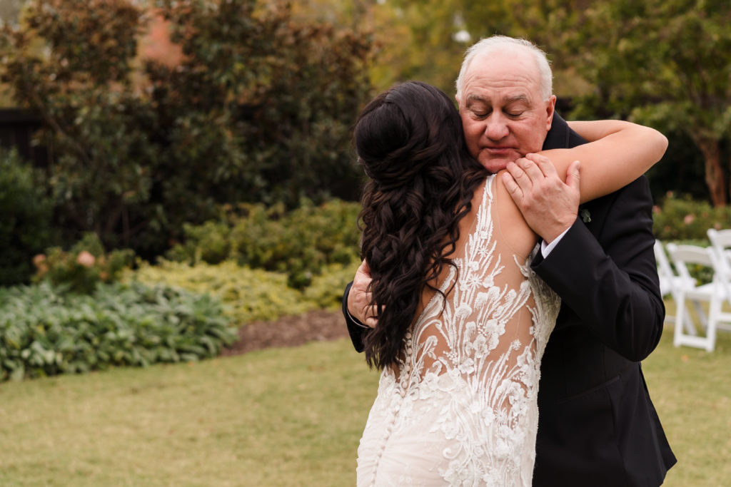 Dad hugs his daughter before her wedding at Sweet Magnolia Estate