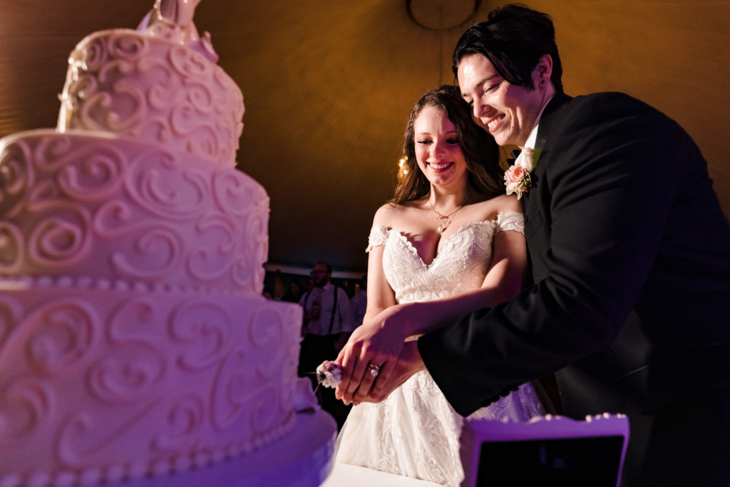 Bride and Groom cutting their wedding cake during their wedding reception at Castle McCulloch
