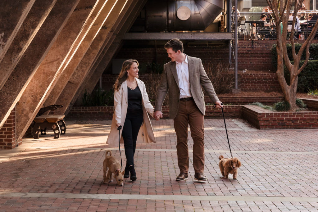 Couple and dogs walking at American Tobacco Campus