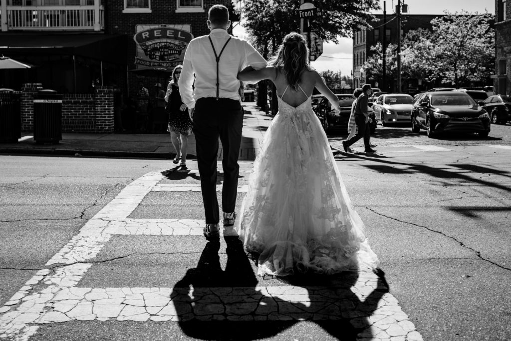wedding couple crossing street while bar hopping