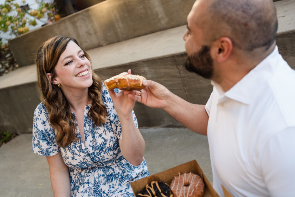 Couple eating donuts during Charlotte engagement session