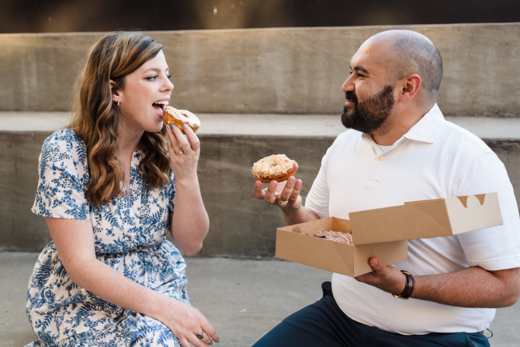 Couple eating donuts during engagement session