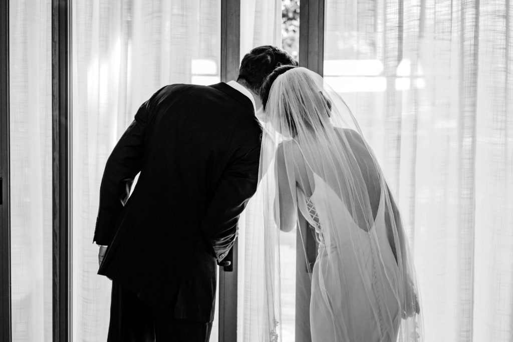 Bride and Groom peeking at ceremony space before their Haiku I Do wedding.