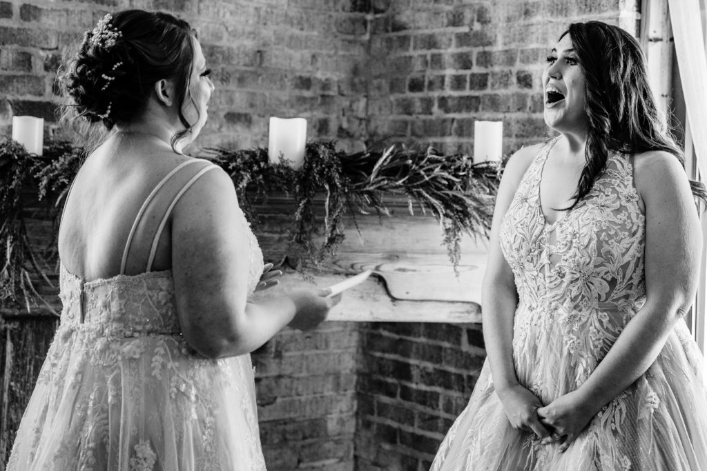 First look between two brides at industrial wedding venue