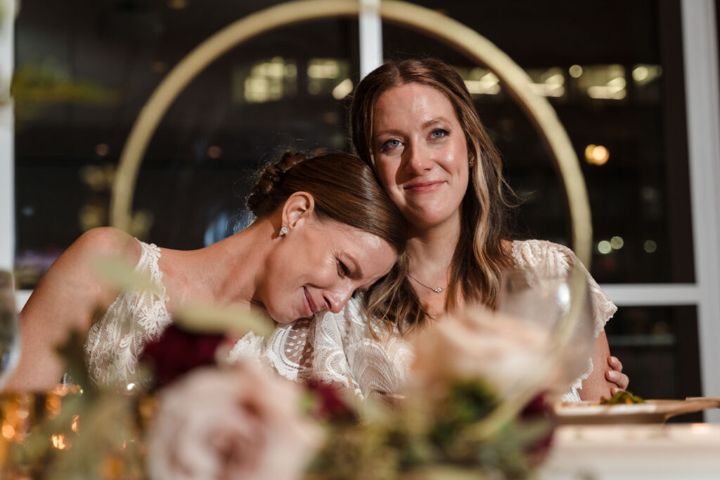 Sweet moment between two brides at nontraditional Mint Museum wedding