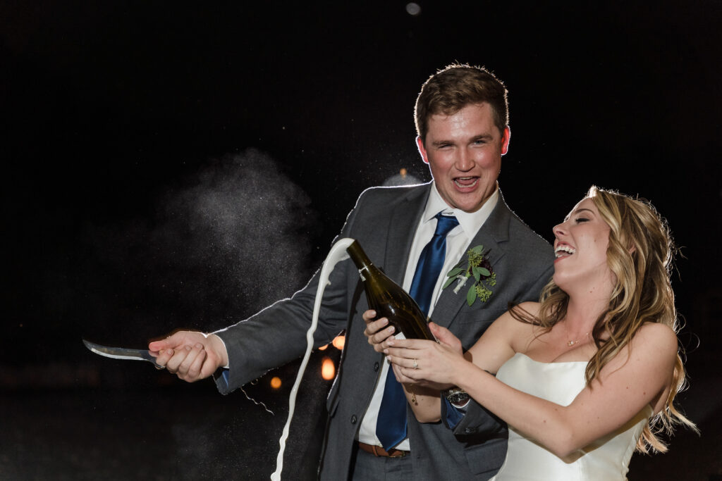 Popping champagne at Pineville Barn Wedding