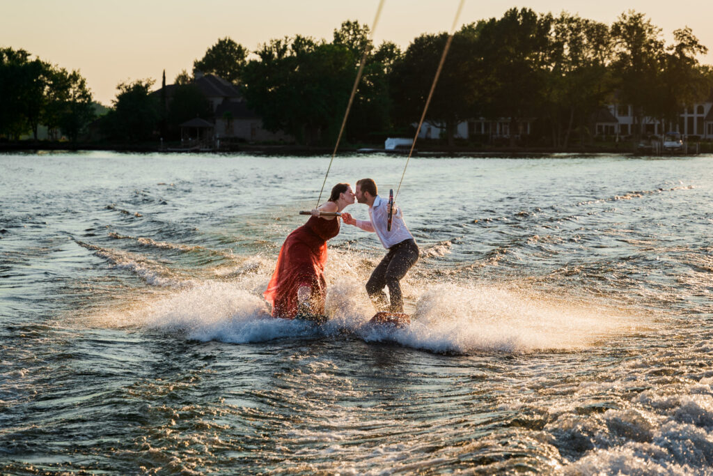 Couple kisses while wakeboarding for engagement session photos