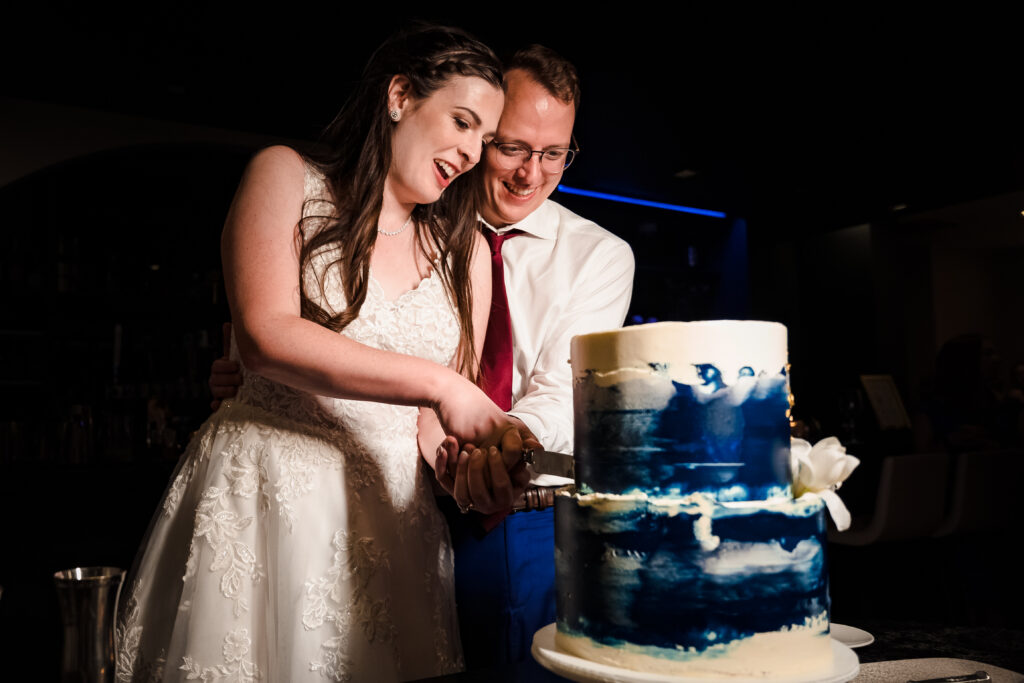 Cake cutting at intimate cocktail bar wedding