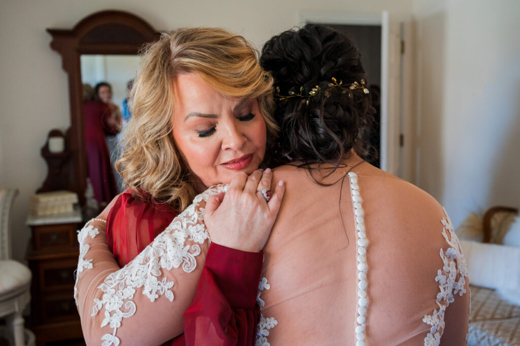 A mom hugging her bride as she's about to get married at Pleasant Grove Farm in Charlotte North Carolina