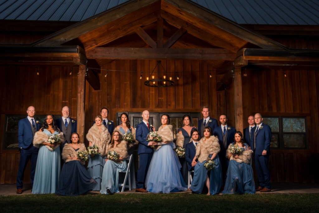 Dramatic wedding party portrait in the style of royalty or the Kardashians outside of the barn at Pleasant Grove Farm