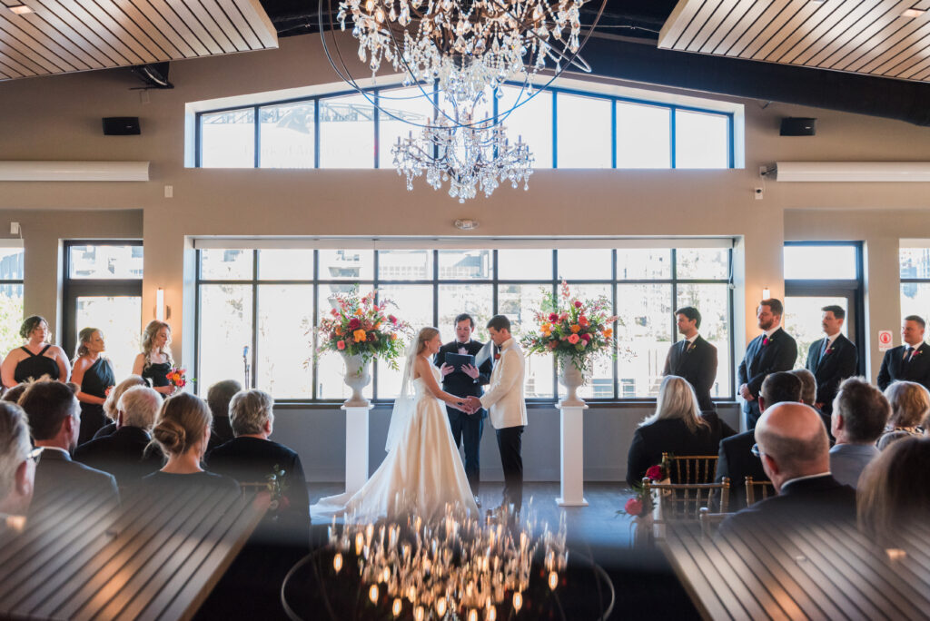 Bride and Groom have wedding ceremony surrounded by Spring flowers at Terrace at Cedar Hill Venue in Charlotte