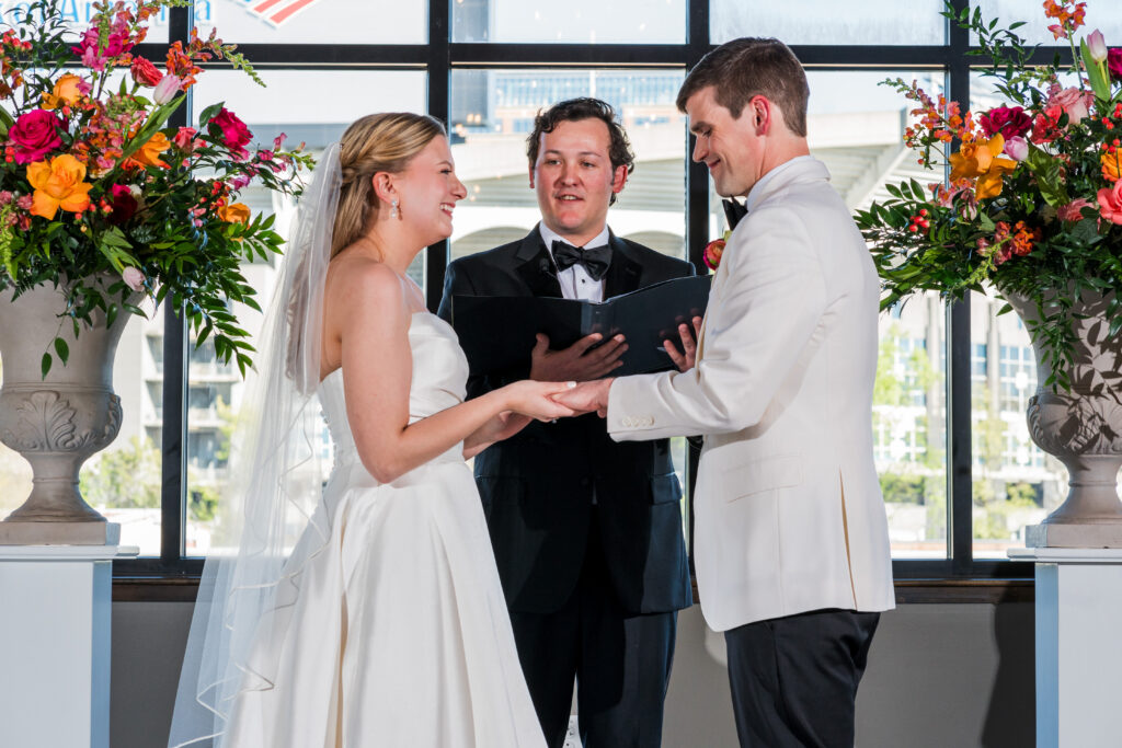 Bride and Groom have wedding ceremony surrounded by Spring flowers at Terrace at Cedar Hill Venue in Charlotte