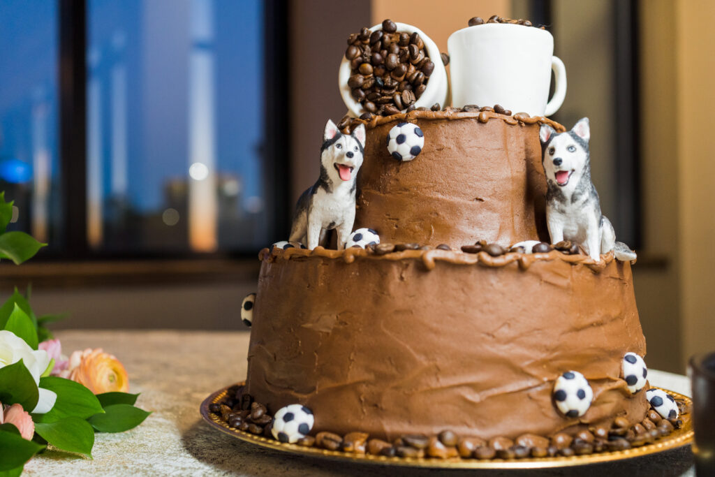 A creative homemade cake honoring the bride and groom's dogs as well as coffee beans.