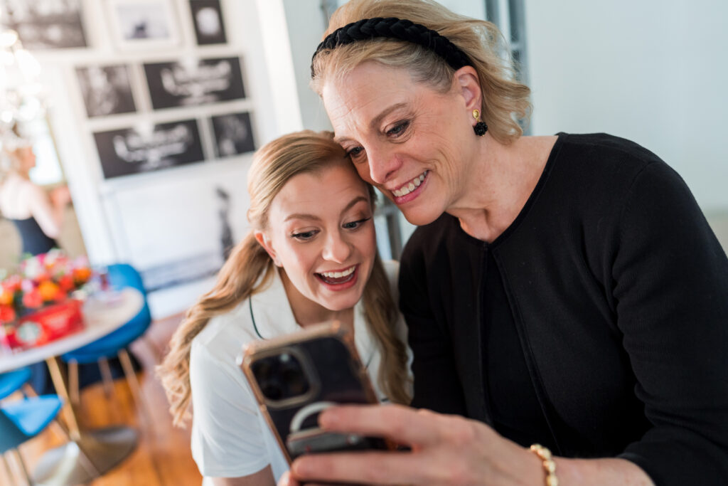 Bride and mother look at phone at Bungalow 1325 in Charlotte NC