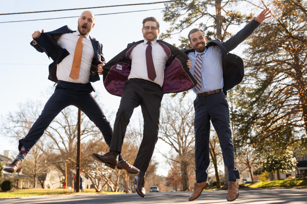 Groomsmen photo jumping in the air doing the Anchorman New Suits pose with jackets