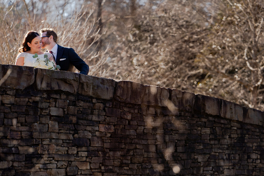 Bride and Groom winter wedding portrait on bridge at Freedom Park in Charlotte North Carolina