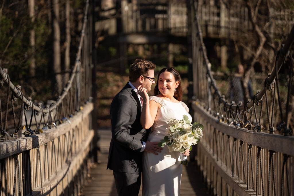 Bride and Groom New Years Eve wedding photo on suspension bridge in Freedom Park, Charlotte NC