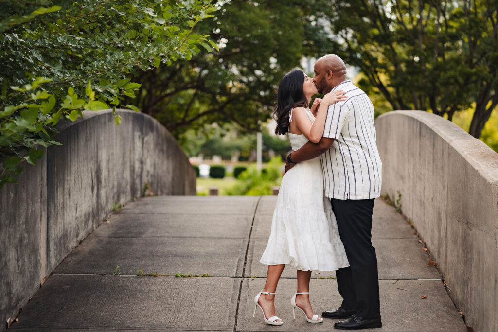 Engagement photos on bridge at Marshall Park in Charlotte.